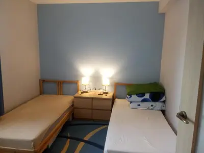 a small room with two beds and a sink at Chata Mego Brata in Limanowa