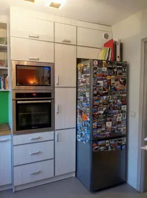 a refrigerator in a kitchen with many pictures on it at Chata Mego Brata in Limanowa