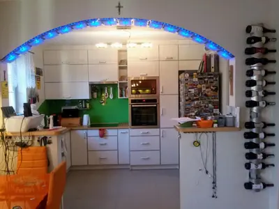 a kitchen with an arch with blue lights in it at Chata Mego Brata in Limanowa