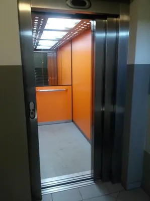 an elevator with an orange door in a room at Chata Mego Brata in Limanowa