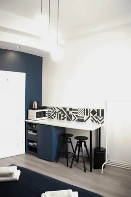 a kitchen with a counter and a table with stools at EURO-ROOM in Kraków