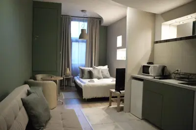 a living room with a bed and a couch in a room at EURO-ROOM in Kraków