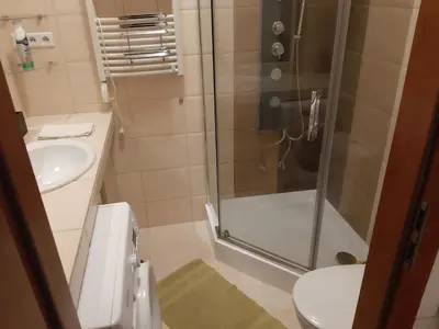 a bathroom with a shower and a toilet and a sink at EURO-ROOM in Kraków