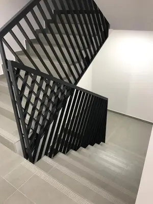 a staircase with black railings in a house at Apartamenty Platinex 2 in Kraków