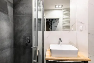 a bathroom with a sink and a mirror at Apartamenty Platinex 2 in Kraków