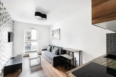 a living room with a couch and a table at Apartamenty Platinex 2 in Kraków