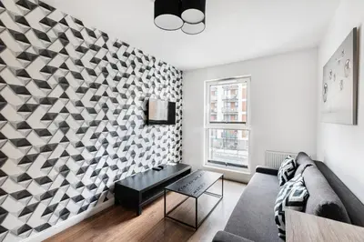 a room with a desk and a tv and a window at Apartamenty Platinex 2 in Kraków