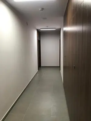 an empty hallway with a white wall and a door at Apartamenty Platinex 2 in Kraków