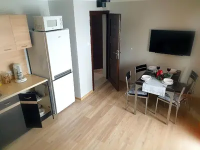 a small room with a table and a refrigerator at Noclegi w gorcach in Ponice