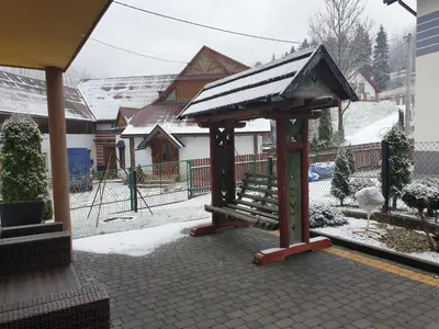 a gazebo with a bench in the snow at Noclegi w gorcach in Ponice