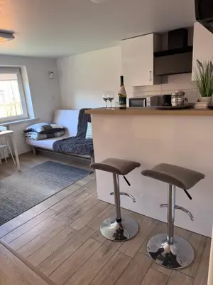 a bedroom with a bed and a table and chairs at Fredry 15F in Kraków