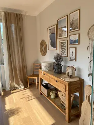 a living room with a table and pictures on the wall at Apartament Joanna in Rabka