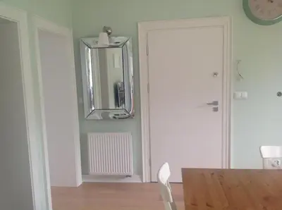 a dining room with a mirror and a table at Apartament Joanna in Rabka