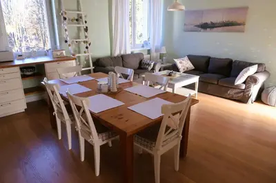 a living room with a wooden table and chairs at Apartament Joanna in Rabka