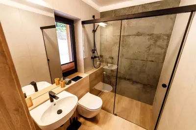 a bathroom with a toilet and a sink and a shower at Kocierska Chata in Kocierz Rychwałdzki