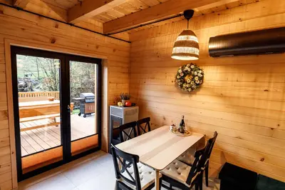 a dining room with a table and a window at Kocierska Chata in Kocierz Rychwałdzki