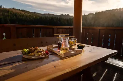a wooden table with a tray of food on a balcony at Kocierska Chata in Kocierz Rychwałdzki