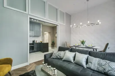a living room with a table with flowers on it at Kings City - Zyblikiewicza 14 apartment in Kraków