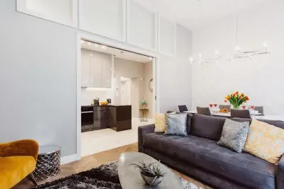 a living room with a couch and a table at Kings City - Zyblikiewicza 14 apartment in Kraków