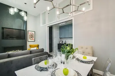 a dining room with a table and a couch at Kings City - Zyblikiewicza 14 apartment in Kraków