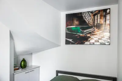 a living room with a picture of a grand piano at AgroPrzystań in Zubrzyca Górna