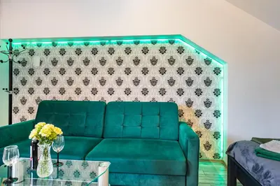a green couch in a living room with a table at AgroPrzystań in Zubrzyca Górna