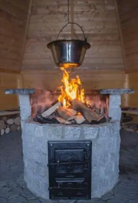 a fire pit with a bucket on top of it at AgroPrzystań in Zubrzyca Górna