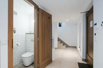 a bathroom with a toilet and a staircase at Słoneczny Chełm - Apartamenty w górach, Prywatna sauna jacuzzi balia w cenie, Spa, Grill, Stok narciarski Myślenice, Ścieżki rowerowe, Rzeka Raba, Widok na Tatry in Myślenice