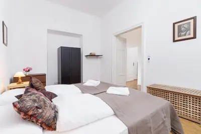 a white bedroom with a large white bed with pillows at Apartment Pijarska Kraków by Noclegi Renters in Kraków
