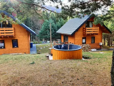 a large wooden tub in front of a house at Domki na Mosornym in Zawoja