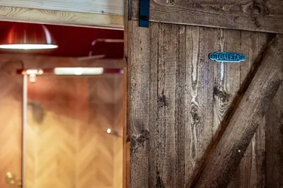 a wooden wall with a sign on it at Domki na Mosornym in Zawoja