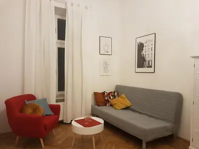 a living room with a couch and a red chair at Zakamarki in Kraków