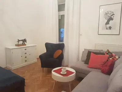 a living room with a couch and a chair at Zakamarki in Kraków