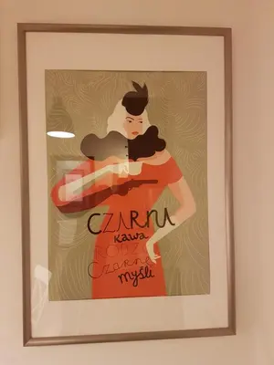 a framed picture of a woman in a red dress at Zakamarki in Kraków