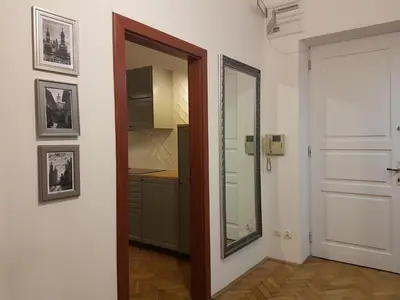 a room with a door and a mirror and a kitchen at Zakamarki in Kraków