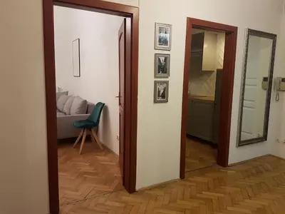 a hallway with a door and a chair in a room at Zakamarki in Kraków