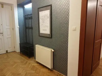a hallway with a radiator and a picture on a wall at Zakamarki in Kraków