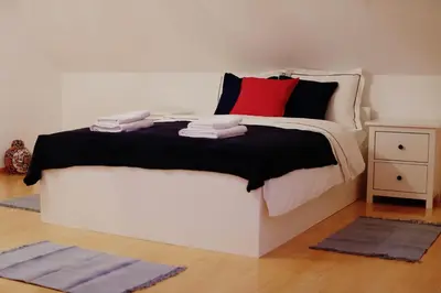 a bedroom with a bed with red and black pillows at Villa pod Szczeblem Dom dla 12 osób z kominkiem balią jacuzzi in Kasinka Mala