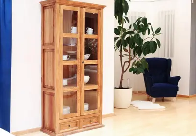 a wooden cabinet in a room with a chair and a plant at Villa pod Szczeblem Dom dla 12 osób z kominkiem balią jacuzzi in Kasinka Mala