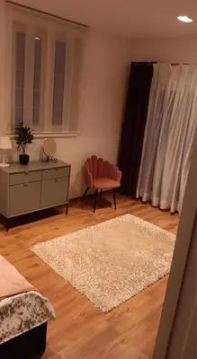 a bedroom with a bed and a chair and a rug at Villa pod Szczeblem Dom dla 12 osób z kominkiem balią jacuzzi in Kasinka Mala
