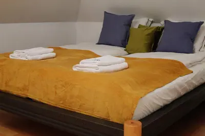 a bed with towels stacked on top of it at Villa pod Szczeblem Dom dla 12 osób z kominkiem balią jacuzzi in Kasinka Mala