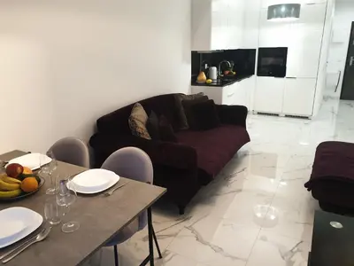 a living room with a couch and a table at Lovely Apartment near Wawel in Kraków