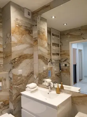 a bathroom with a sink and a mirror at Lovely Apartment near Wawel in Kraków