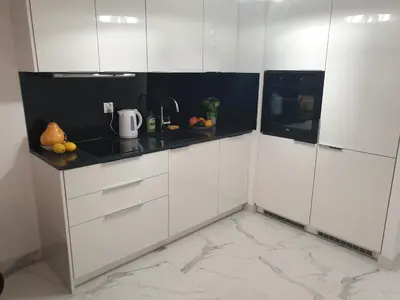 a white kitchen with black and white cabinets at Lovely Apartment near Wawel in Kraków