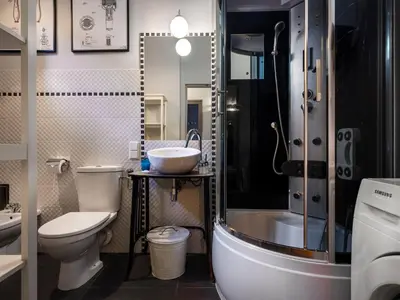 a bathroom with a sink and a toilet and a shower at CracWoW Market Squere Apartment in Kraków
