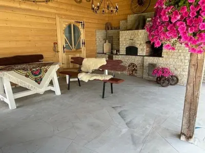 a living room with a fireplace and a table and chairs at U Kowola - Gospodarstwo Agroturystyczne in Węglówka