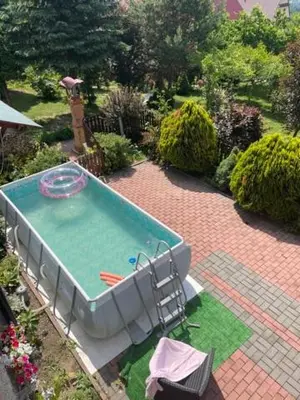 a swimming pool in a garden with aitating at U Kowola - Gospodarstwo Agroturystyczne in Węglówka