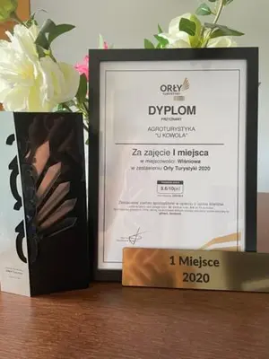 a picture and a box on a table with a flower at U Kowola - Gospodarstwo Agroturystyczne in Węglówka