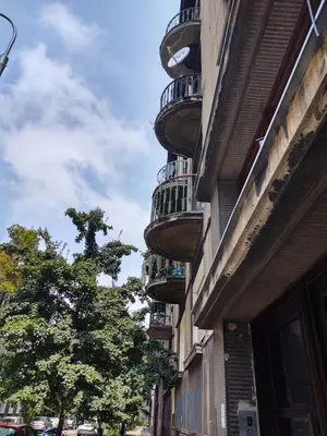 a building with balconies on the side of a street at Little Big Red - Central Modern Studio in Kraków