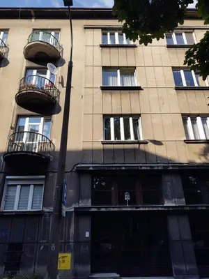 a tall building with balconies on the side of it at Little Big Red - Central Modern Studio in Kraków